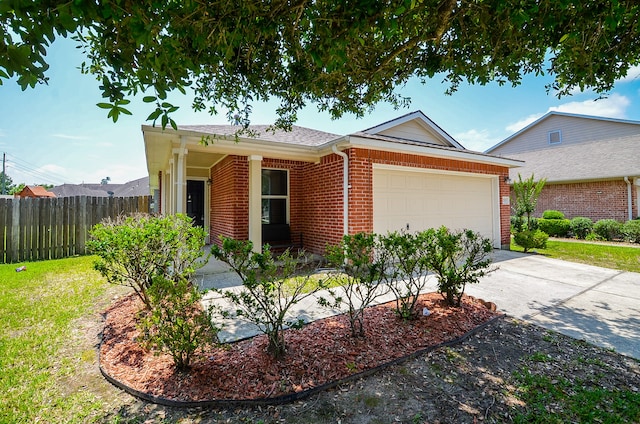 view of front of home featuring driveway, a front yard, a garage, brick siding, and fence