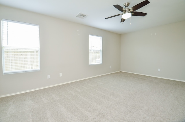 carpeted empty room featuring ceiling fan