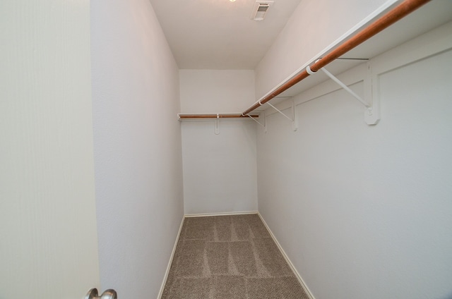spacious closet featuring carpet flooring and visible vents