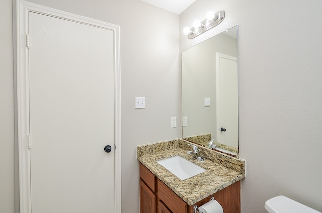 bathroom featuring toilet and vanity