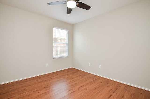 spare room featuring hardwood / wood-style flooring and ceiling fan