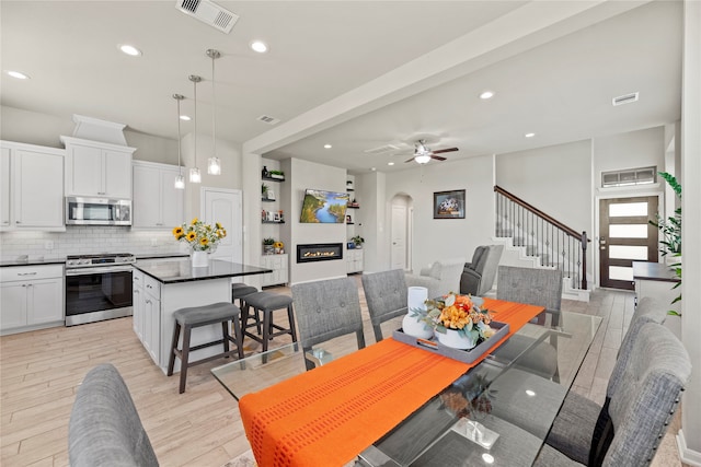 dining room with light hardwood / wood-style floors and ceiling fan