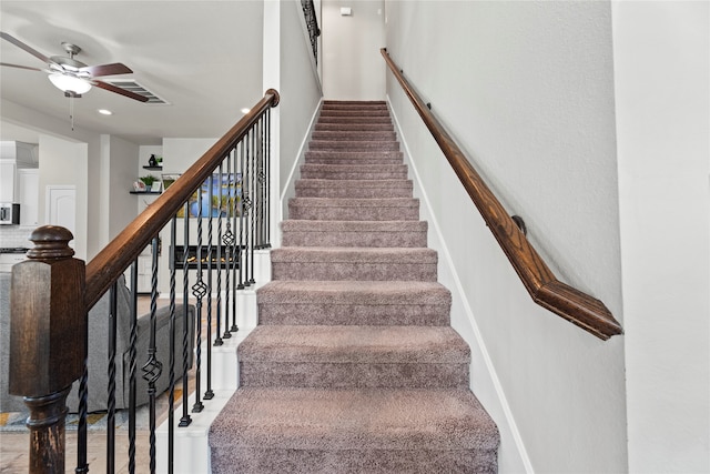 stairway with ceiling fan