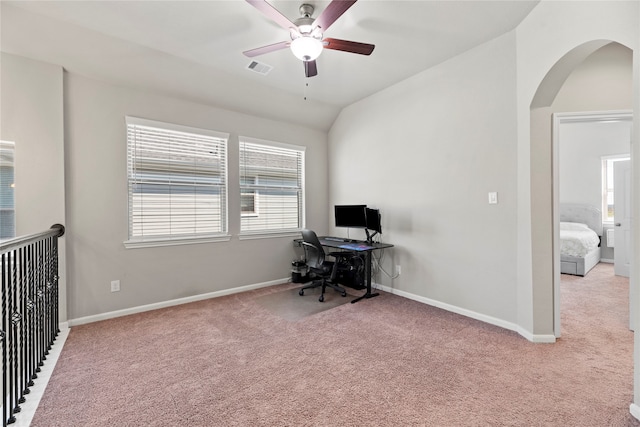 carpeted home office featuring lofted ceiling and ceiling fan