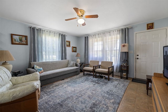 living room featuring ceiling fan and a wealth of natural light