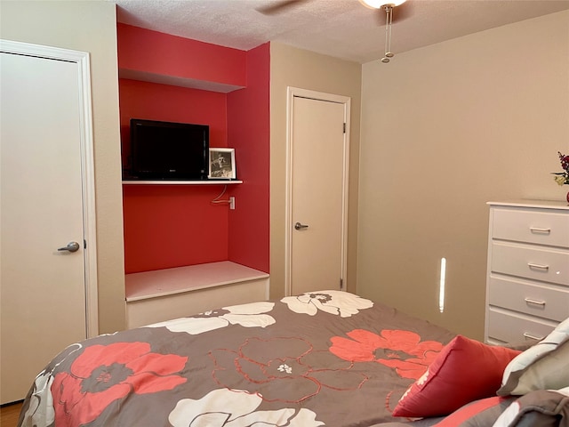 bedroom featuring ceiling fan and a textured ceiling