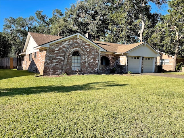 ranch-style house featuring a front lawn and a garage