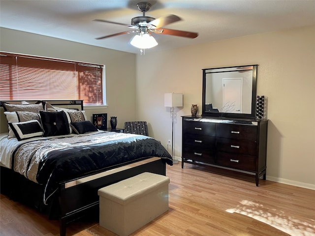 bedroom with light hardwood / wood-style floors and ceiling fan