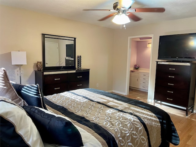 bedroom with connected bathroom, ceiling fan, and light wood-type flooring