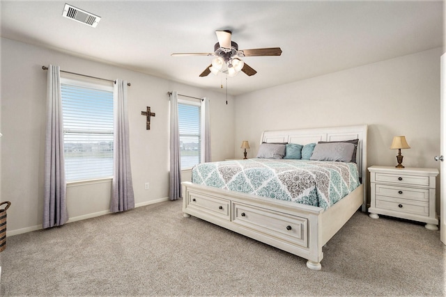 bedroom with ceiling fan and light colored carpet