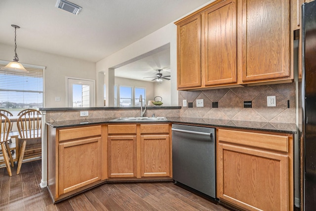 kitchen with dishwasher, sink, kitchen peninsula, refrigerator, and decorative light fixtures