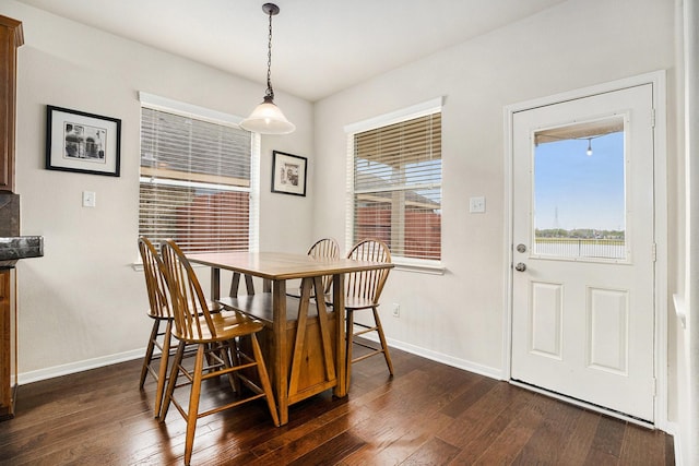 dining area with dark hardwood / wood-style floors