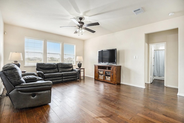 living room featuring dark hardwood / wood-style floors and ceiling fan