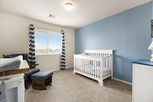 carpeted bedroom with a nursery area