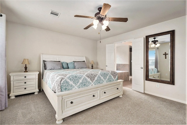 bedroom featuring carpet, ensuite bathroom, and ceiling fan