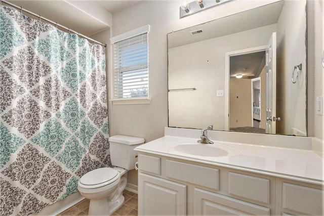 bathroom with tile patterned flooring, vanity, and toilet