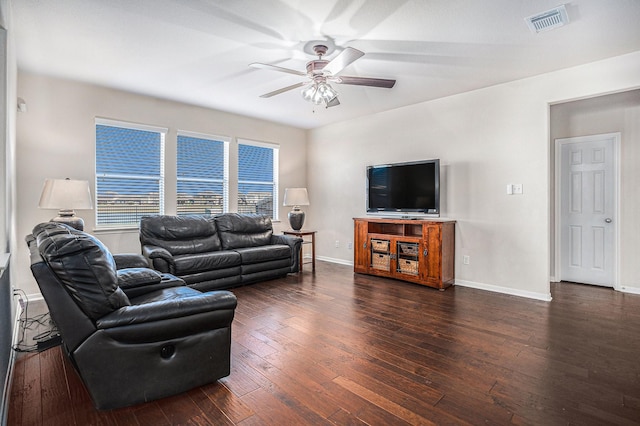 living room with ceiling fan and dark wood-type flooring