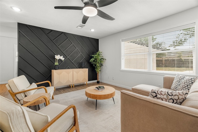 sitting room featuring light hardwood / wood-style flooring and ceiling fan