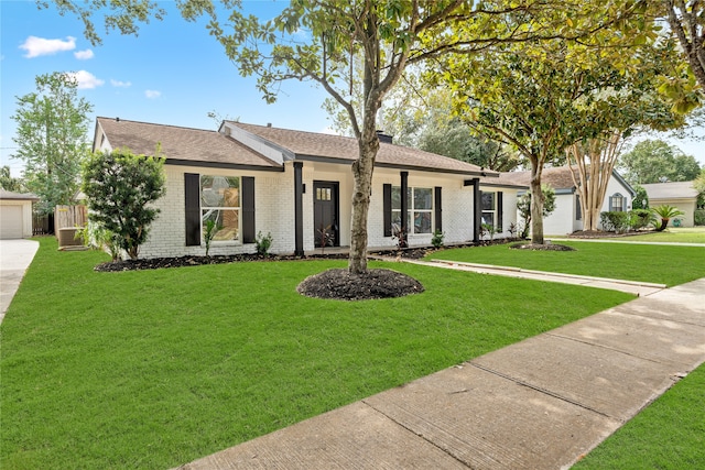 ranch-style house featuring a front yard and a garage