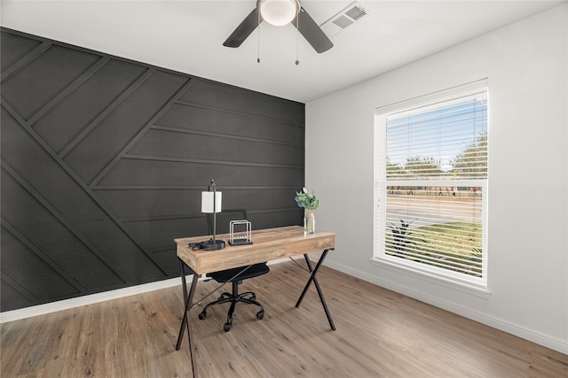 office space featuring light hardwood / wood-style floors, a healthy amount of sunlight, and ceiling fan