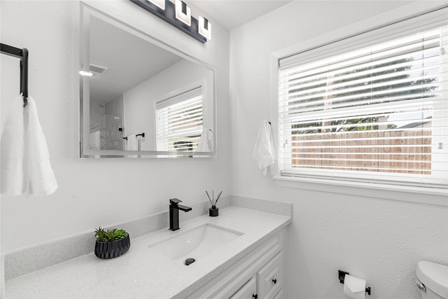 bathroom featuring toilet and vanity