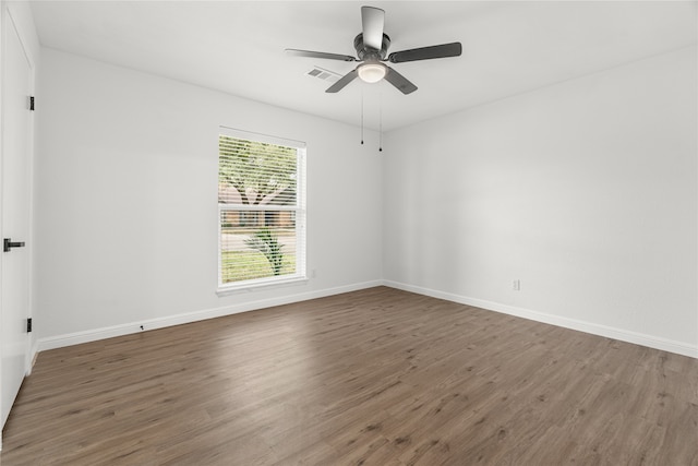 spare room with ceiling fan and dark hardwood / wood-style flooring