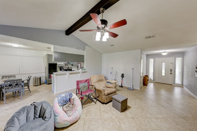 living room featuring ceiling fan, lofted ceiling with beams, and light tile patterned floors