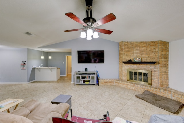 tiled living room with lofted ceiling, ceiling fan, and a brick fireplace