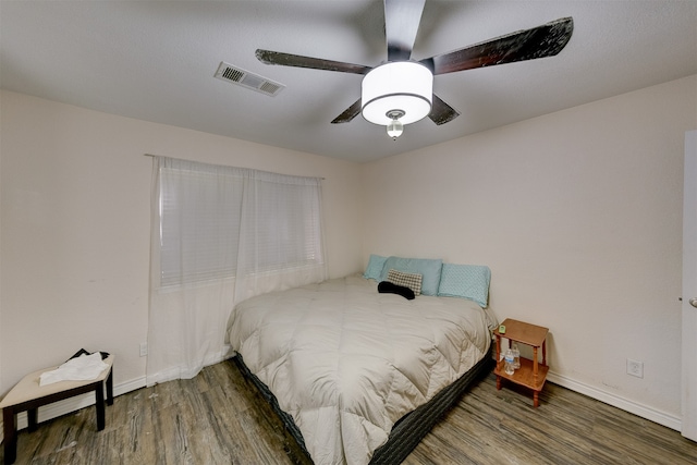 bedroom with dark wood-type flooring and ceiling fan