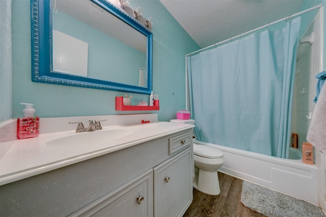 full bathroom with a textured ceiling, hardwood / wood-style flooring, toilet, shower / bath combo, and vanity