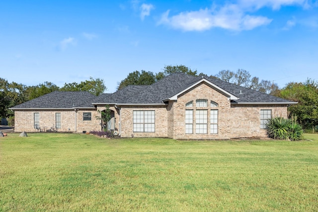 back of property featuring a lawn