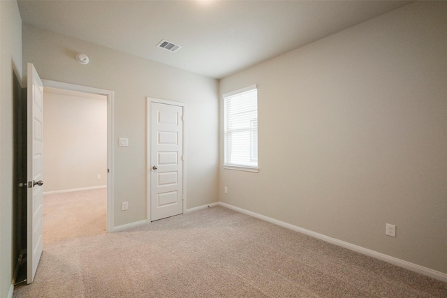 unfurnished bedroom featuring light carpet