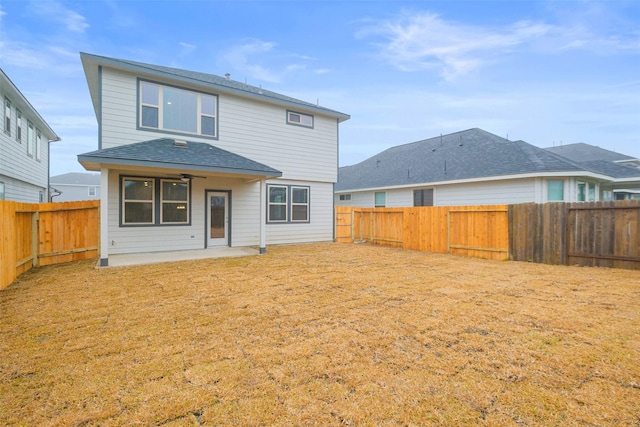 rear view of house with a yard and a patio