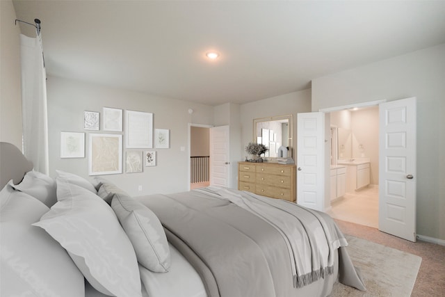 carpeted bedroom with ensuite bath