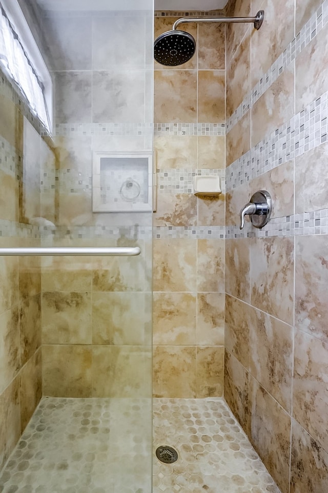 bathroom with a tile shower