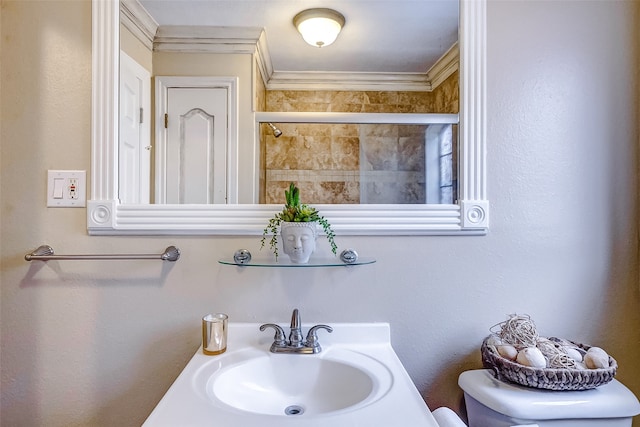 bathroom featuring walk in shower, toilet, ornamental molding, and sink