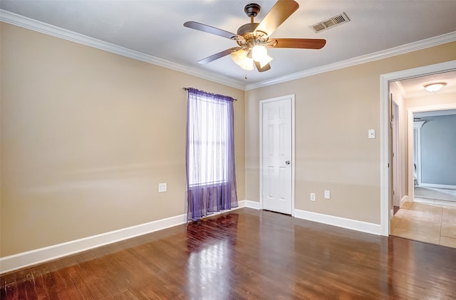 spare room featuring crown molding, dark hardwood / wood-style floors, and ceiling fan