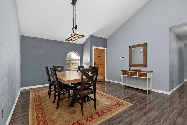 dining area featuring dark hardwood / wood-style floors and high vaulted ceiling