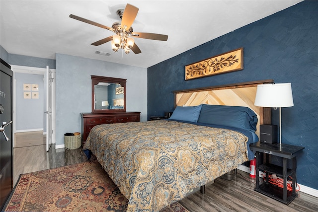 bedroom with ceiling fan and dark hardwood / wood-style floors