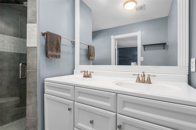 bathroom with vanity and a shower with shower door