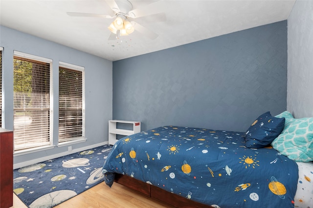 bedroom with hardwood / wood-style flooring and ceiling fan