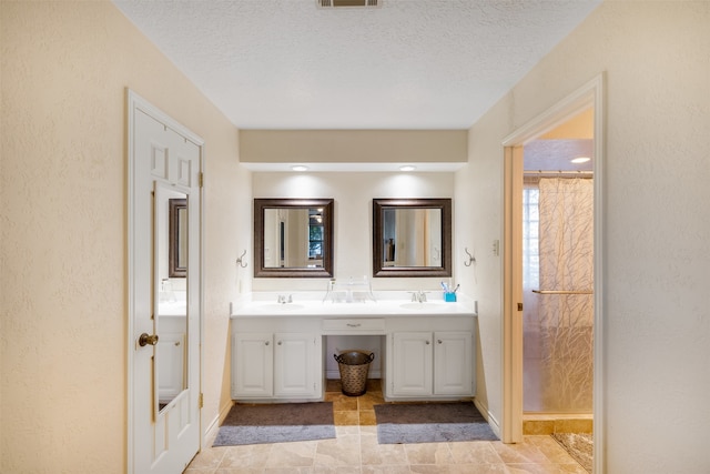 bathroom with a textured ceiling and vanity