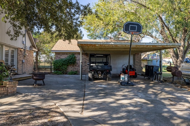 view of patio featuring an outbuilding and a garage