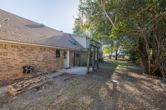 view of yard featuring central AC unit and a patio