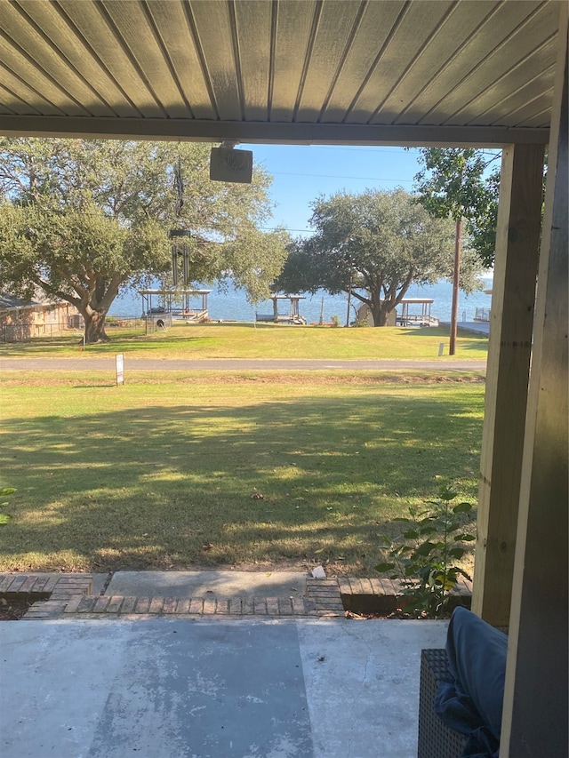 view of yard with a patio and a water view