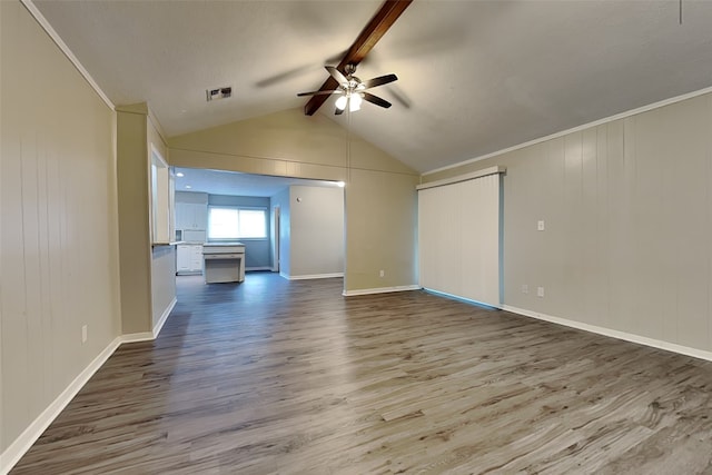 unfurnished living room featuring crown molding, hardwood / wood-style flooring, lofted ceiling with beams, and ceiling fan