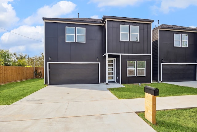 view of front of home featuring a garage and a front lawn