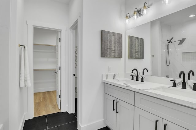 bathroom featuring vanity, a shower, and wood-type flooring