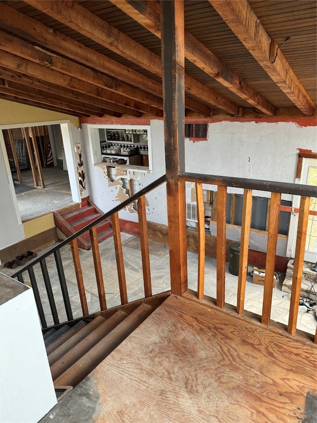 stairway featuring vaulted ceiling and bar