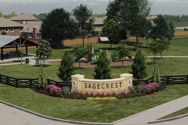 community sign featuring fence and a lawn